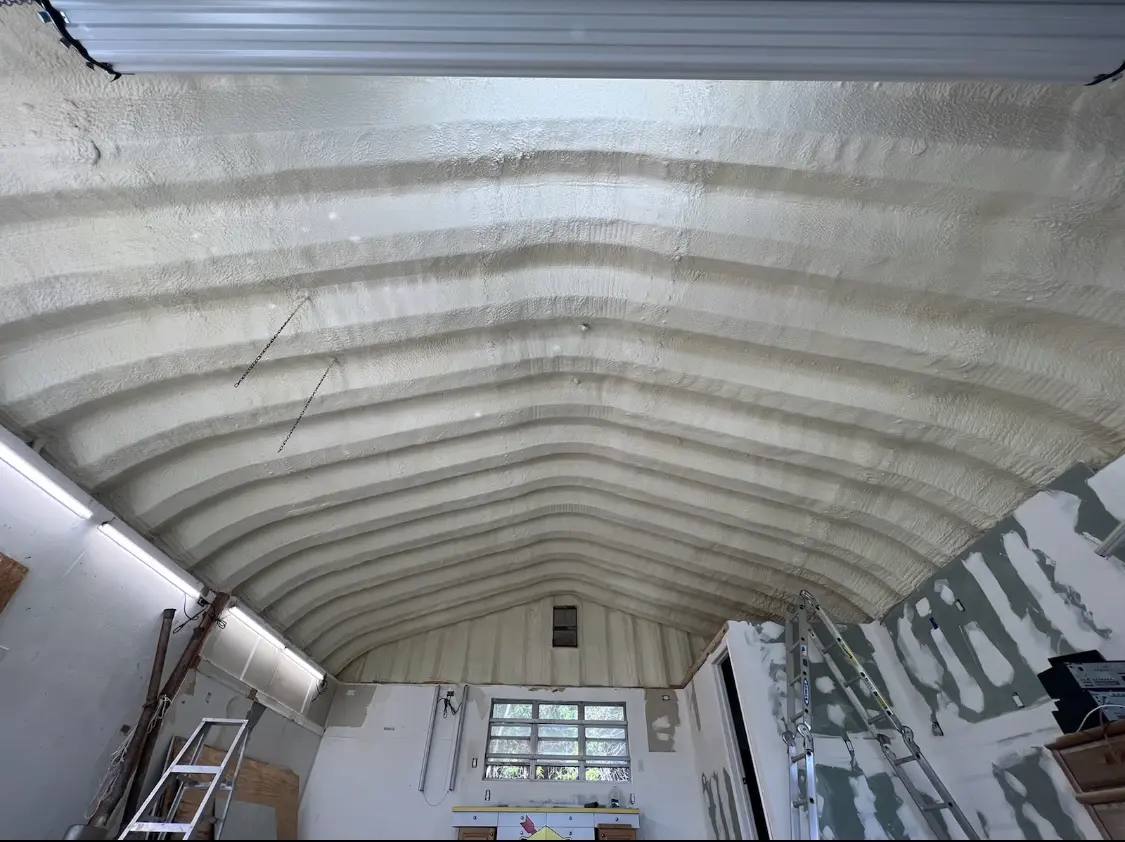 Spray polyurethane foam applied to the underside of a metal roof deck in East Milton